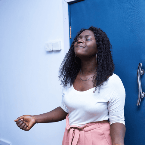 Image of woman in white shirt and pink skirt worshipping